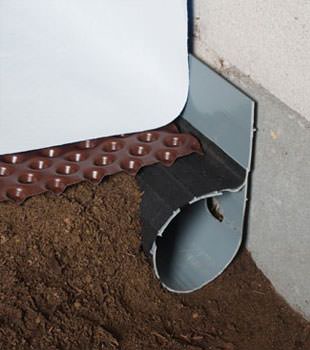 Closeup of a crawl space drainage system installed in Poteet