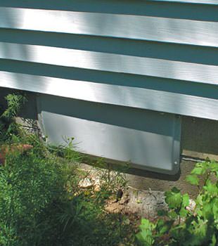 A gray crawl space vent cover in Floresville