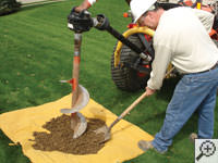 Auguring a hole in the earth for a foundation repair in Uvalde
