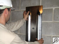 Mounting a foundation wall plate for an earth anchor installation in Boerne.