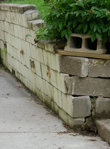 collapsing retaining wall with severe damage in Cuero