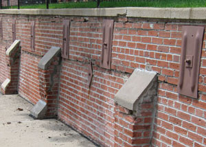 Rusted wall plate anchors in a retaining wall repair in Crystal City.