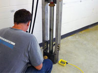 Driving foundation piers into the floor in Converse.