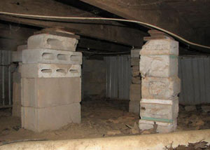 crawl space repairs done with concrete cinder blocks and wood shims in a Lockhart home