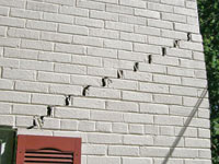 Stair-step cracks showing in a home foundation in Gonzales