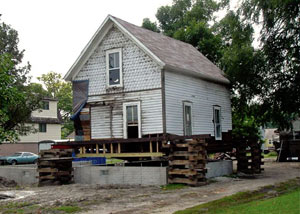 A severely damaged home foundation that is undergoing replacement in Pearsall.