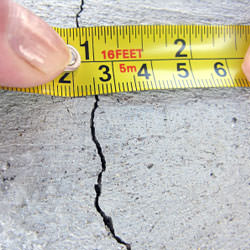 A crack in a poured concrete wall that's showing a normal crack during curing in Cibolo