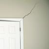 A long drywall crack beginning at the corner of a doorway in a Pleasanton home.