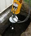 Installing a helical pier during a foundation repair in New Braunfels