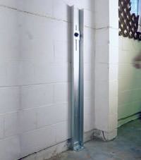 A failing foundation wall repaired with a foundation wall channel anchor system in a San Marcos home.