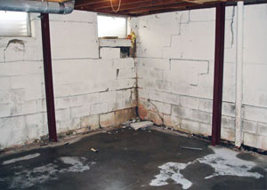 A failed, rusty i-beam foundation wall system installed in Poteet.