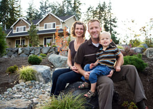 A happy family outside a home with a repaired foundation in Alta Vista