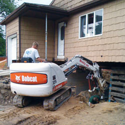 Excavating to expose the foundation walls and footings for a replacement job in Boerne