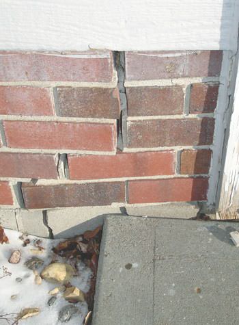 Severe street creep damage to a garage wall outside a Olmos Park home