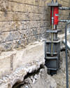 A completed installation of foundation push piers lifting a foundation in Floresville