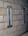 an inside view of foundation wall anchors installed along a basement wall to brace and repair the structure in Universal City
